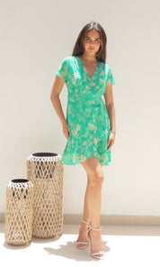 Female model wearing Rose Wrap Frill Mini Dress - Green- showcasing the latest ladies fashion with free delivery 