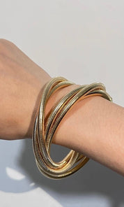 Female model wearing Sena Tangled Gold Bracelet- showcasing the latest ladies fashion with free delivery 