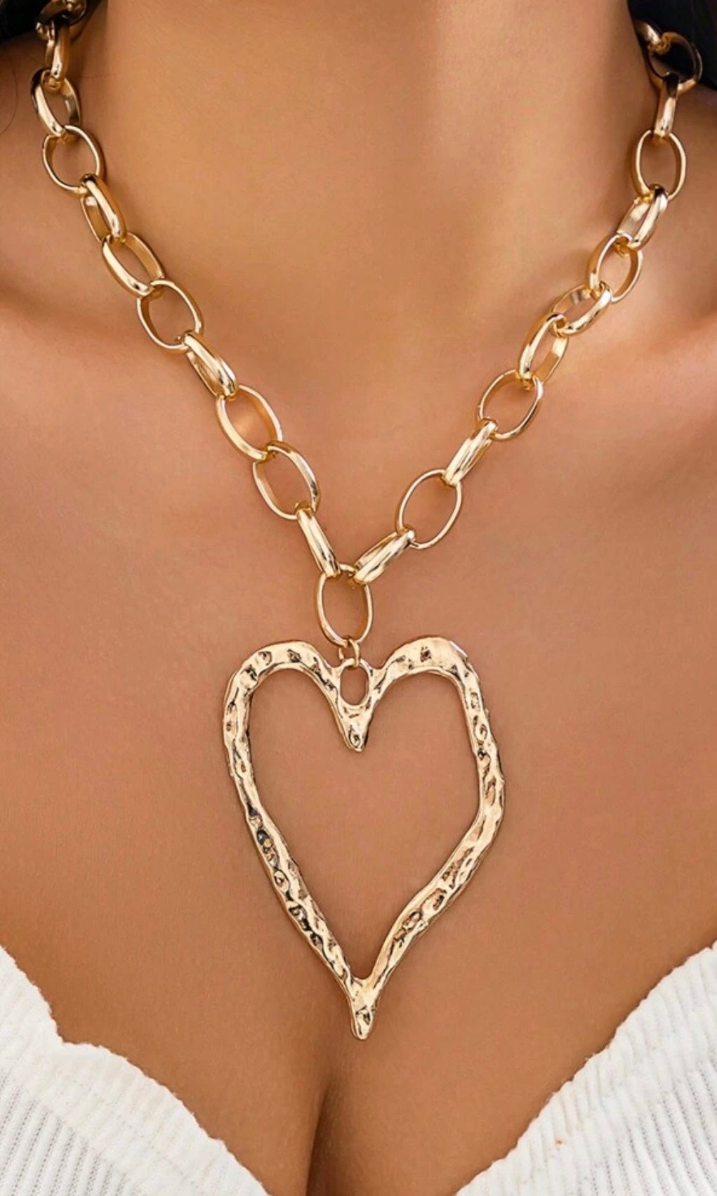 Female model wearing Geneva Heart-shaped Gold Necklace- showcasing the latest ladies fashion with free delivery 