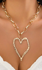 Female model wearing Geneva Heart-shaped Gold Necklace- showcasing the latest ladies fashion with free delivery 