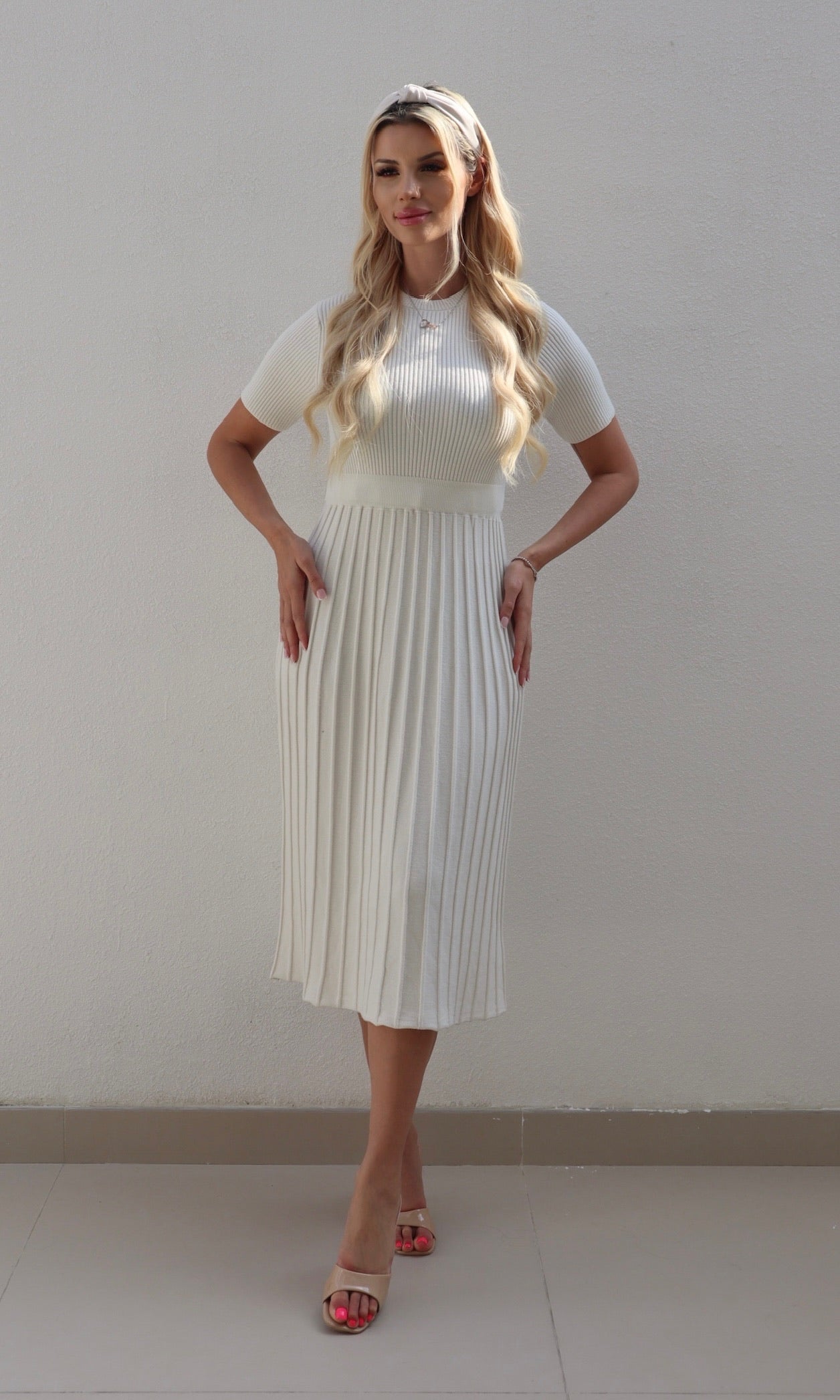 Female model wearing Carla knitted pleat Dress - Cream- showcasing the latest ladies fashion with free delivery 