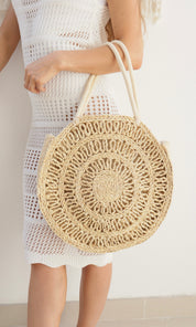 Female model wearing Rosie Circular Straw Bag - Natural- showcasing the latest ladies fashion with free delivery 